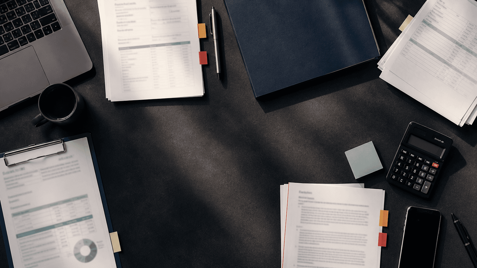 Confidential business documents and financial information on a management desk